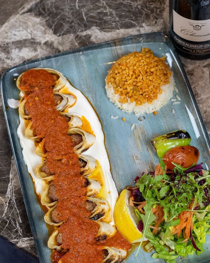 Turkish beyti served with a glass of red wine